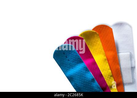 Macro shot detail of first aid dressing (Plaster) with non-stick pad for quick wound healing. Colorful set of sterile wound dressing isolated on white Stock Photo