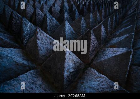 Sharp tip concrete architecture texture background. Art picture of unique pattern of dark stone carving in pointed triangle shape. Concept of obstacle Stock Photo