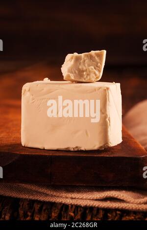 A block of compressed fresh yeast. Stock Photo