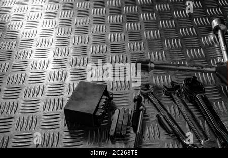 Tools on industrial metal checker plate. Metal checkerplate for anti skid. Wrench, and hex key on metal sheet floor. Silver bump ground with art patte Stock Photo