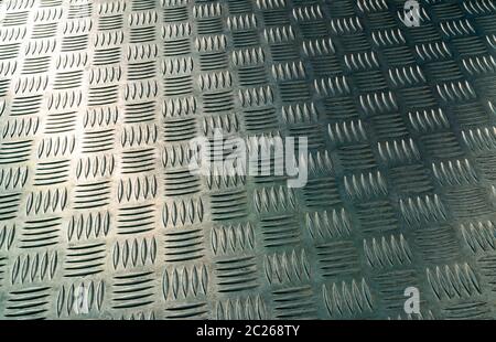 Industrial metal checker plate. Metal checker plate texture background. Metal checkerplate for anti skid. Embossed metal sheet floor. Silver bump grou Stock Photo