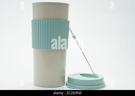 Modern thermos bottle isolated on white background. Coffee, tea, and warm water bottle. White and green thermos bottle  with blank label. Insulated bo Stock Photo