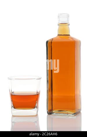Glass cup and bottle of whiskey on white background Stock Photo