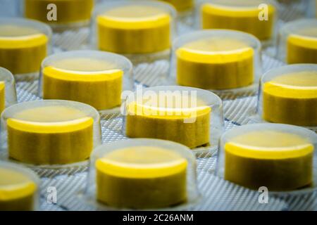 Macro shot detail of yellow tablets pill in blister pack. Full frame of tablet pills Stock Photo