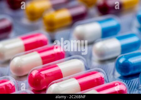 Colorful antibiotic capsule pills in blister pack. Pharmaceutical industry. Pharmacy drugstore background. Antibiotic drug resistance. Antimicrobial c Stock Photo