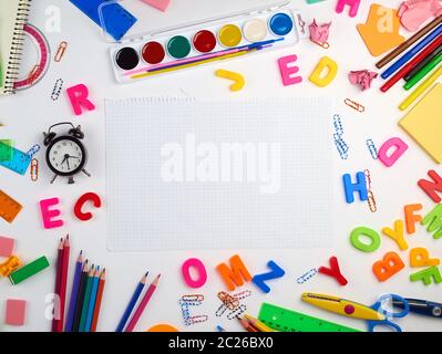 blank white squared notebook sheet and diverse school supplies, back to school concept Stock Photo