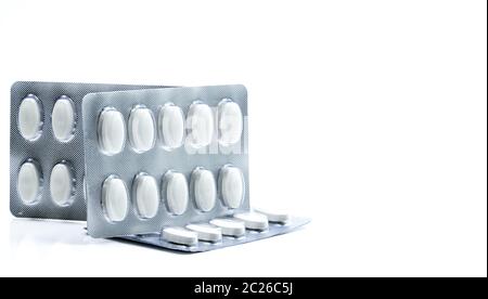 Vitamins and supplements tablets in blister pack on white background. Antioxidants for healthy skin. Good supplement pills for woman bone. Stock Photo