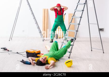Injured worker and his workmate Stock Photo