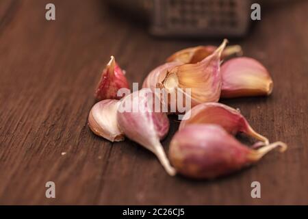masher for garlic and garlic on a wooden Stock Photo