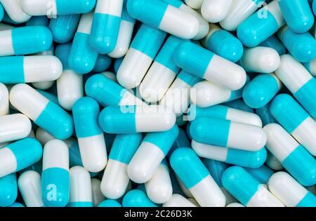 Top view pile of blue and white antibiotic capsule pills texture. Pharmaceutical production. Global healthcare. Antibiotics drug resistance. Antimicro Stock Photo