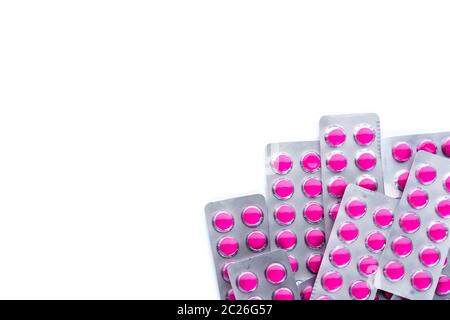 Round pink tablets pills in blister packs on white background with copy space. Ibuprofen tablets pills for relief pain, high fever, headache, toothach Stock Photo