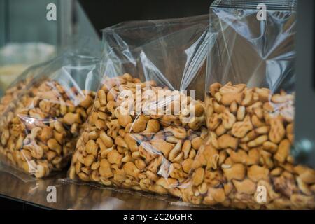 Salted Fish Crackers in packages on store shelves, cookies snacks. Selective focus. Stock Photo