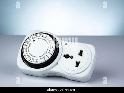 Plug-in timer mechanical 24 hour. Indoor home tools. Plug-in timer socket set isolated on white background. Mechanical outlet timer. Home security sup Stock Photo