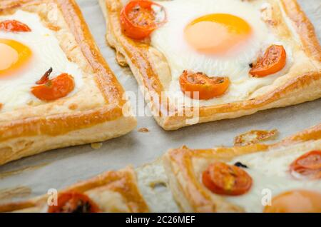 Tomato, Egg, and Prosciutto Tart from puff pastry, baked in oven Stock Photo