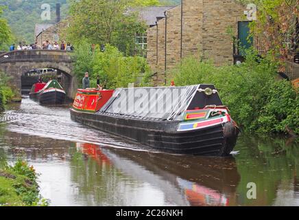 vintage boats traveling to the historic narrow boat club gathering held on the may bank holiday on the rochdale canal at hebden Stock Photo