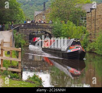 vintage boats traveling to the historic narrow boat club gathering held on the may bank holiday on the rochdale canal at hebden Stock Photo