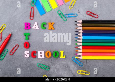 The layout of school supplies on a dark gray background. The view from the top. Back to school. Flat lay Stock Photo