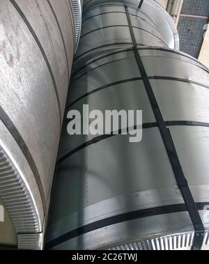 Steel sheets rolled up into rolls. Export Steel. Packing of steel for transportation. Stock Photo