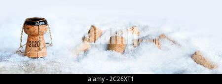 Champagne corks in snow at the turn of the year 2020 Stock Photo