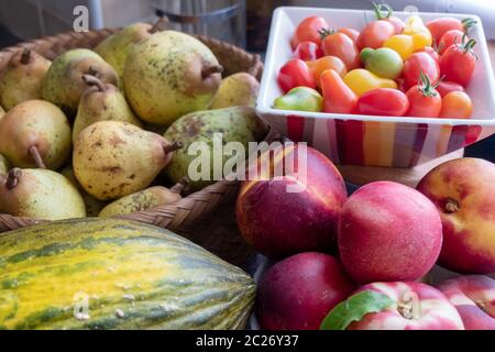 organic fruits from garden, tomatoes, pears, peaches Stock Photo