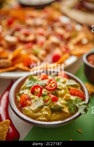 Nachos with Guacamole (close-up shot) on wooden background Stock Photo ...