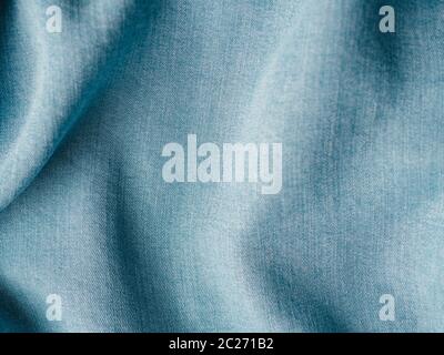 Modern soft jeans blouse texture close up. Lyocell or tencel pattern - modern natural cellulose fabric blue denim color. Can use for design or text. C Stock Photo