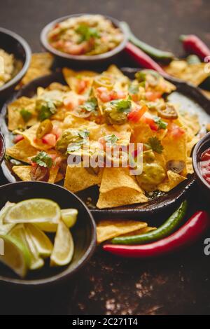 Tasty mexican nachos chips served on ceramic plate Stock Photo