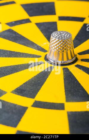 a thimble on an dartboard - symbol foto Stock Photo