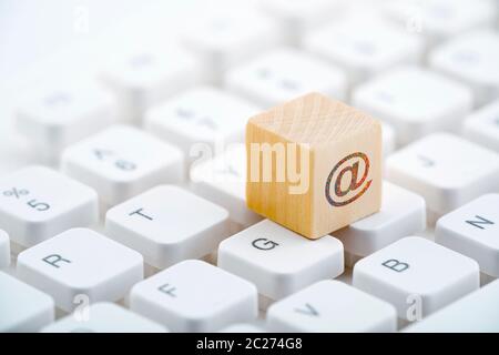 Wooden block with colorful internet symbol on computer keyboard Stock Photo