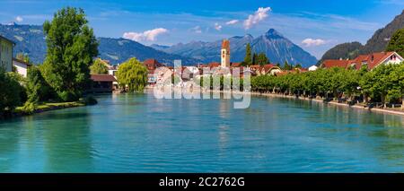 Panoramic view of Old City of Unterseen with Church and Aare river, Interlaken, important tourist center in the Bernese Highlands, Switzerland Stock Photo