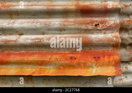 Rust on old corrugated metal sheets of a house wall Stock Photo