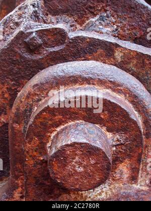 a close up of an axle and pieces on old rusted abandoned industrial machinery Stock Photo