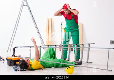 Injured worker and his workmate Stock Photo