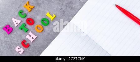 The layout of school supplies on a dark gray background. The view from the top. Back to school. Flat lay Stock Photo