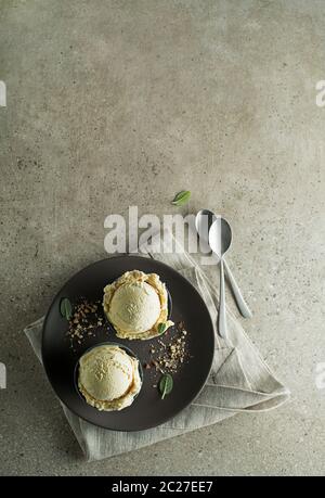 Homemade Organic Vanilla Ice Cream scoops in a plate close up Stock Photo