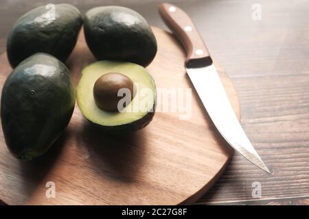 close up of slice of avocado on chopping board. Stock Photo