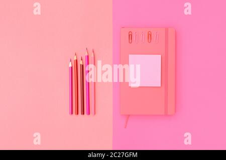 Pink notepad, pencil and marker on pink background. Flat lay. Concept office and back to school. Stock Photo
