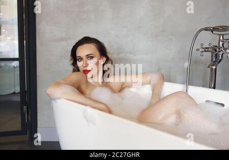 Happy young woman relaxing in bathtub Stock Photo