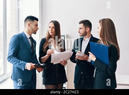 Young business people discussing new business project in office Stock Photo