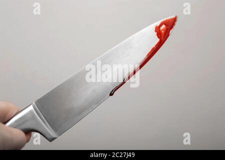 A knife smeared with blood. A murder weapon. Photo icon Crime background scary horror Stock Photo