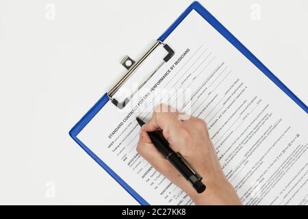 Signing standart contract for live performance by musicians. A musician filling live performance contract Stock Photo