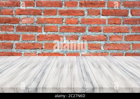 White wooden table top on brick wall. For product display Stock Photo