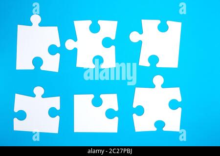 empty white big puzzles on a blue background. Concept in business Stock Photo