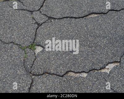 cracked black tarmac texture useful as a background Stock Photo