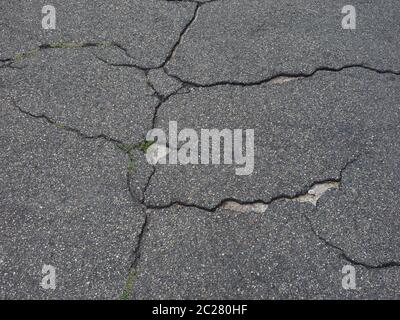 cracked black tarmac texture useful as a background Stock Photo