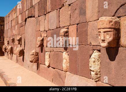 Carved stone head sculptures in the semi subterranean courtyard temple in Tiwanaku, La Paz, Bolivia. Stock Photo