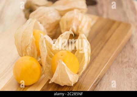 Cape gooseberry (Physalis) on wooden table, healthy fruit and vegetable Stock Photo