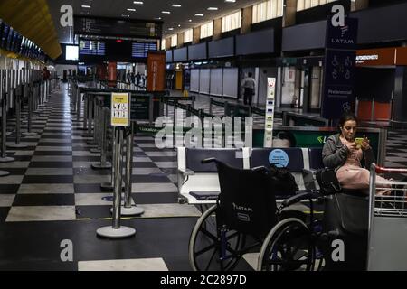 Sao Paulo, Brazil. 16th June, 2020. A woman waits for her flight at Congonhas Airport in Sao Paulo, Brazil, June 16, 2020. Brazil on Tuesday reported 1,282 new deaths from the novel coronavirus in the last 24 hours, taking its total such deaths to 45,241, said the health ministry. The number of infections reached 923,189 after 34,918 more people tested positive for the virus, the largest single-day increase since Brazil's first COVID-19 death was reported three months ago, the ministry said in its daily report. Credit: Rahel Patrasso/Xinhua/Alamy Live News Stock Photo