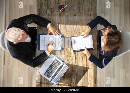 High Angle View Of A Male Manager Interviewing Female Applicant In Office Stock Photo