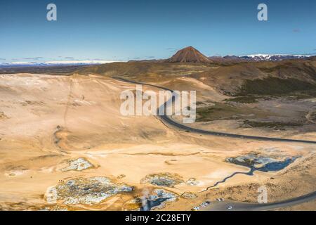 Namafjall Hverir geothermal area in Iceland. Stunning landscape of sulfur valley with smoking fumaroles and blue cloudy sky, travel background, touris Stock Photo
